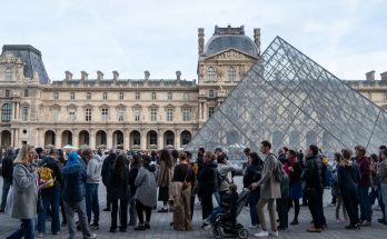 People wait in line outside the Louvre Museum in Paris for its reopening on Oct. 22. (Riccardo Milani/Hans Lucas/AFP via Getty Images)