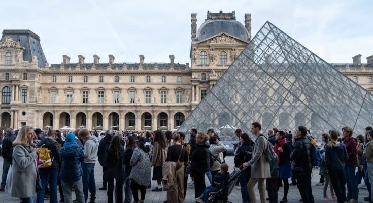 People wait in line outside the Louvre Museum in Paris for its reopening on Oct. 22. (Riccardo Milani/Hans Lucas/AFP via Getty Images)