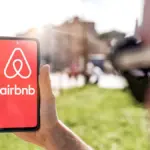 2-april-2023-a-young-man-holds-a-smartphone-with-the-airbnb-app-and-logs-in-for-a-simple-and-conveni.webp